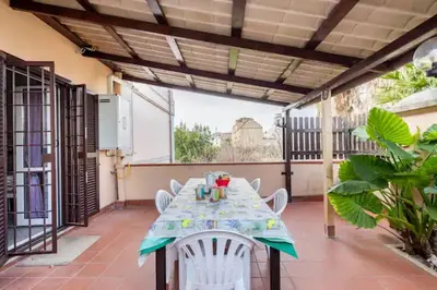 a table and chairs on the balcony of a house at Appartamento per chi ama gustare il caffè in terrazzo in Rome