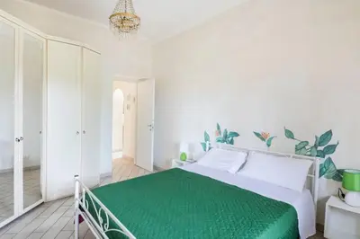 a bedroom with a large bed with a green blanket at Appartamento per chi ama gustare il caffè in terrazzo in Rome