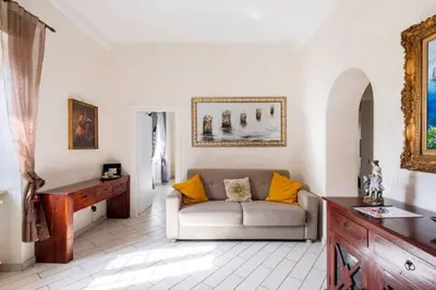 a living room with a couch and a table at Appartamento per chi ama gustare il caffè in terrazzo in Rome