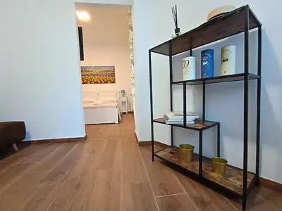 a room with a shelf with books and a painting at SAN PAOLO ROMA HOLIDAY HOME in Rome