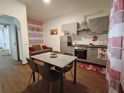 a kitchen and living room with a table and chairs at SAN PAOLO ROMA HOLIDAY HOME in Rome