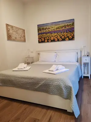 a bedroom with a bed with two towels on it at SAN PAOLO ROMA HOLIDAY HOME in Rome