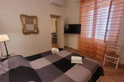 a bedroom with a large bed and a mirror at casa vacanza vaticano in Rome