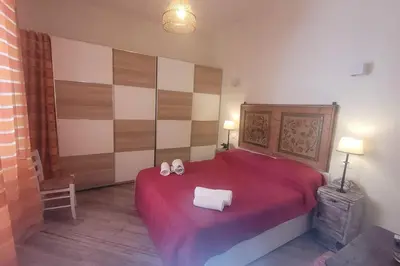 a bedroom with a red bed with two towels on it at casa vacanza vaticano in Rome