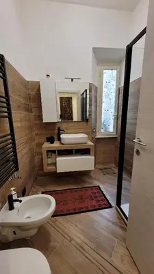 a bathroom with a sink and a toilet and a mirror at casa vacanza vaticano in Rome