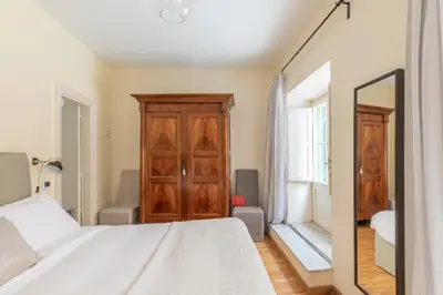 a bedroom with a bed and a mirror at iFlat Little & Bright in Trevi in Rome