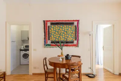 a dining room with a table and a painting on the wall at iFlat Little & Bright in Trevi in Rome