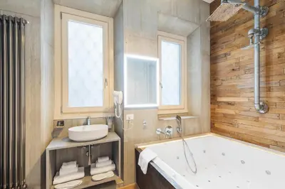 a bathroom with a tub and a sink at Adelante rooms Piazza Bologna in Rome