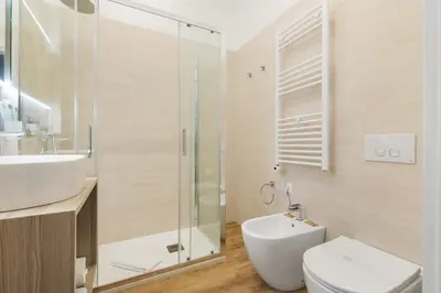 a bathroom with a sink and a toilet and a shower at Adelante rooms Piazza Bologna in Rome