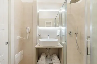 a bathroom with a sink and a shower at Adelante rooms Piazza Bologna in Rome