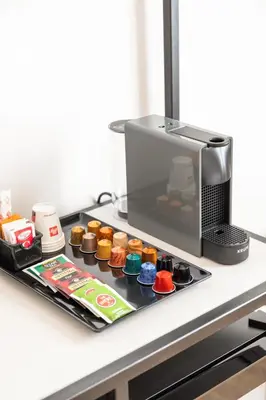 a kitchen counter with a coffee maker and food at Adelante rooms Piazza Bologna in Rome