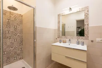 a bathroom with a sink and a mirror at Maison Piazza di Spagna in Rome
