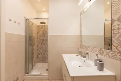 a bathroom with a sink and a shower at Maison Piazza di Spagna in Rome
