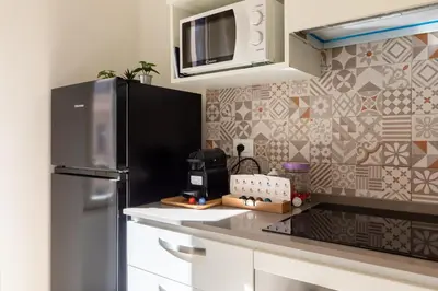 a kitchen with a refrigerator and a microwave at Maison Piazza di Spagna in Rome