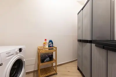 a laundry room with a washer and a refrigerator at Maison Piazza di Spagna in Rome