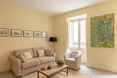 a living room with a couch and a chair at iFlat Lovely in Trevi in Rome