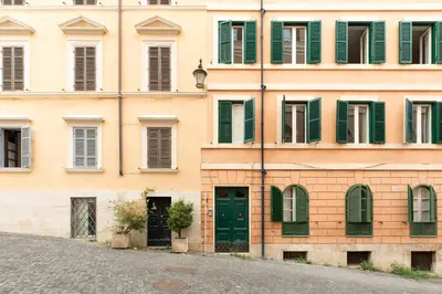 an old building with green doors and windows at iFlat Lovely in Trevi in Rome