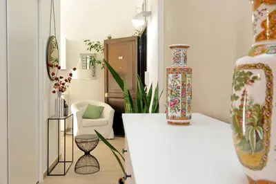 a room with a table with a vase on it at NuvolHouse in Rome