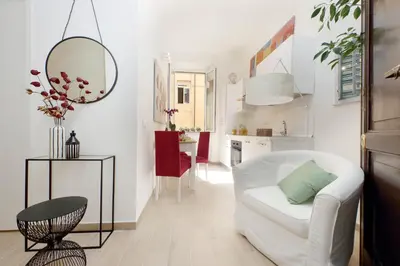 a living room with a white couch and a table at NuvolHouse in Rome