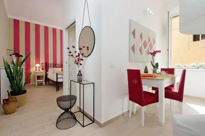 a living room with a table and a mirror at NuvolHouse in Rome