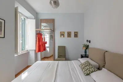a bedroom with a white bed and a couch at iFlat Trevi Charming in Rome