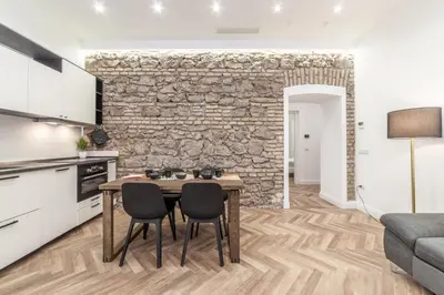 a kitchen and dining room with a table and chairs at Private apartment in Rome