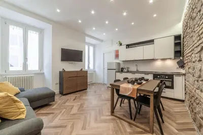 a kitchen and living room with a table and a couch at Private apartment in Rome