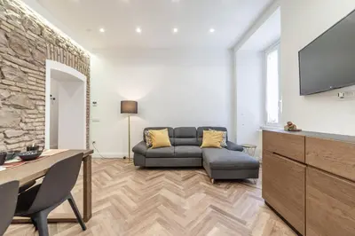 a living room with a couch and a tv at Private apartment in Rome