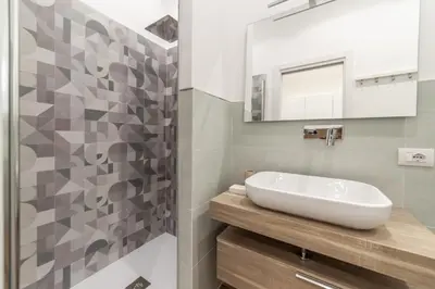 a bathroom with a sink and a mirror at Private apartment in Rome
