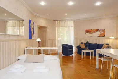 a bedroom with a bed and a living room at Apartment Felice in Rome