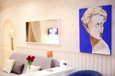 a living room with a painting of a woman on the wall at Apartment Felice in Rome