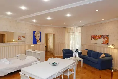 a living room with a bed and a couch and a table at Apartment Felice in Rome