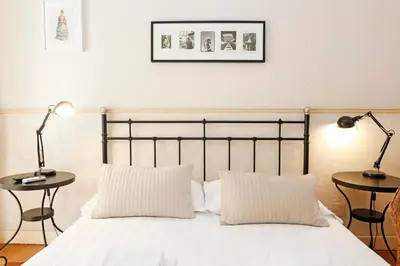 a bedroom with a bed with two tables and two lamps at Apartment Felice in Rome