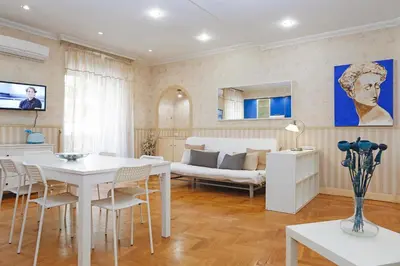 a living room with a white table and a couch at Apartment Felice in Rome