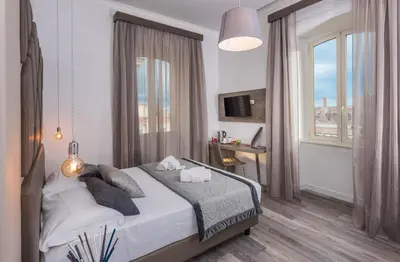 a bedroom with a large bed and a window at Suite Deal in Rome