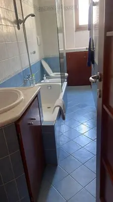 a bathroom with a tub and a sink and a bath tub at Nice flat in Furio Camillo in Rome