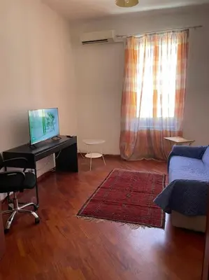 a living room with a desk with a computer and a couch at Nice flat in Furio Camillo in Rome