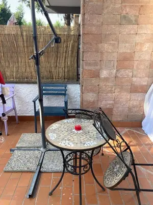 a table and chairs on a patio with an umbrella at Terrace! in Rome