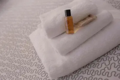 a bottle of sunscreen sitting on top of a white towel at Casa Magiuli' Navona in Rome