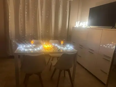 a kitchen with a table with chairs and lights at Rome Maya Home in Rome