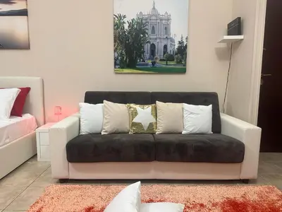 a living room with a black couch with pillows at Rome Maya Home in Rome