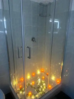 a shower with lights on the floor in a bathroom at Rome Maya Home in Rome