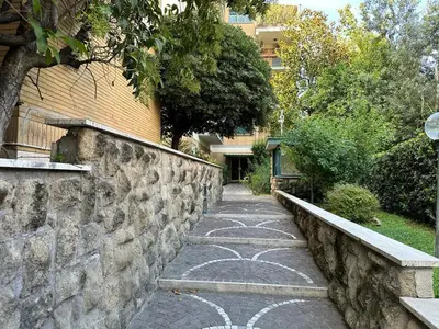 a stone path next to a stone wall at Rome Maya Home in Rome