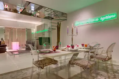 a dining room with a white table and chairs at Domus Domitia Luxury Living in Rome