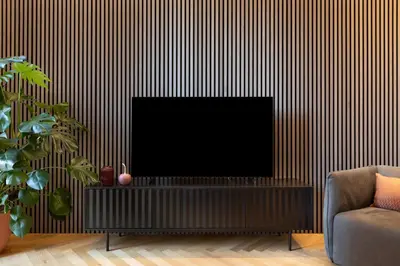 a living room with a flat screen tv on a wall at ROMAC Trinity with steam bath in Rome