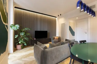 a living room with a couch and a table at ROMAC Trinity with steam bath in Rome