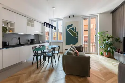 a kitchen and living room with a table and chairs at ROMAC Trinity with steam bath in Rome