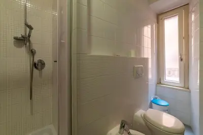 a bathroom with a shower and a toilet and a sink at GuestHost - Roma Termini Comfy Apartment in Rome