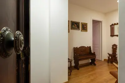 an open door to a living room with a chair at GuestHost - Roma Termini Comfy Apartment in Rome