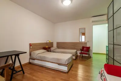 a bedroom with a bed and a desk and a chair at GuestHost - Roma Termini Comfy Apartment in Rome